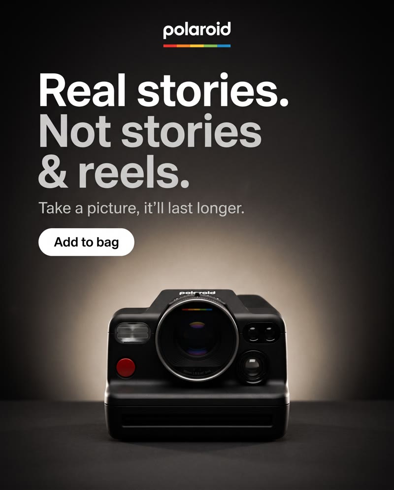 Polaroid I-2 ad: the headline "Real stories. Not stories & reels." above the camera in a pool of warm light