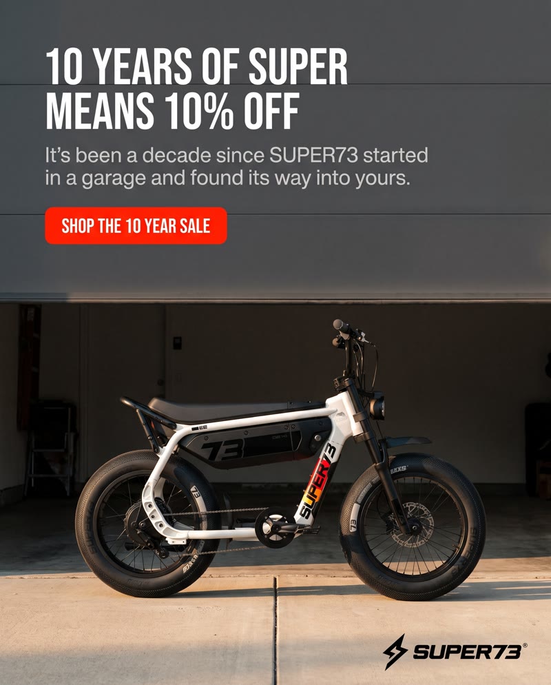 SUPER73 ad: the bike parked in a garage at dusk, with the headline "10 years of SUPER means 10% off" and a red sale button
